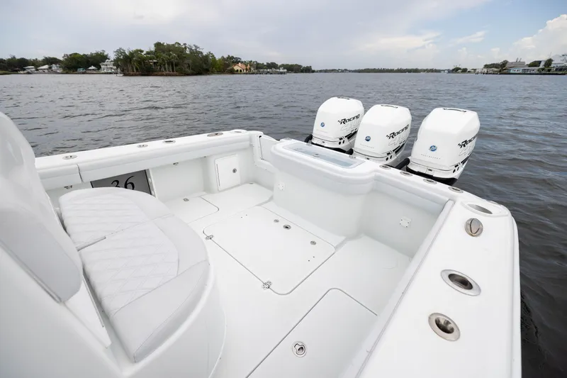 Slide: The Image of 2019 Yellowfin 36 Offshore boat with triple outboard engines on calm water. - 44