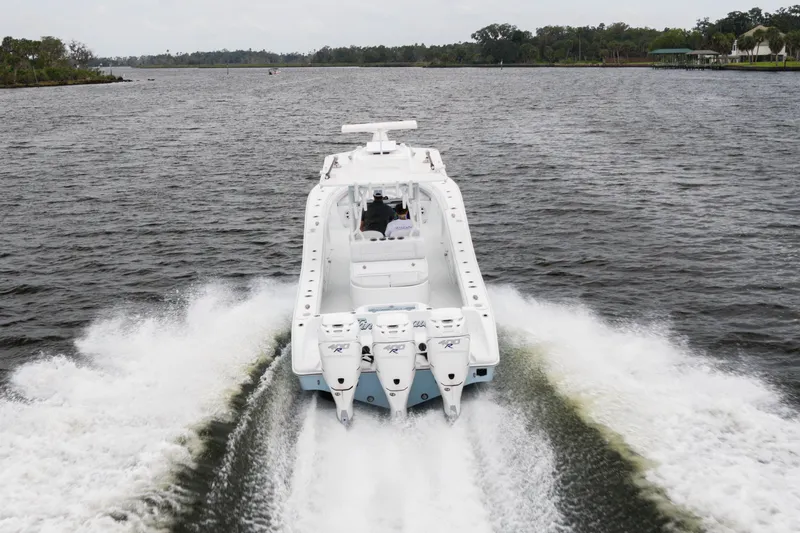 Slide: The Image of 2019 Yellowfin 36 Offshore boat cruising on a scenic waterway. - 10