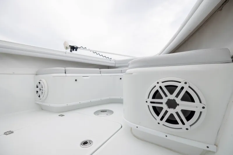 Slide: The Image of 2019 Yellowfin 36 Offshore boat interior with speakers and cushioned seating. - 17
