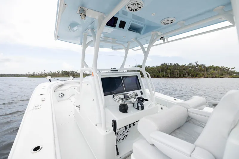 Slide: The Image of 2019 Yellowfin 36 Offshore boat interior with modern helm, on calm waters. - 29