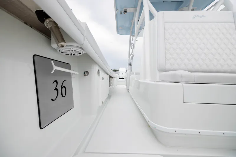 Slide: The Image of 2019 Yellowfin 36 Offshore boat interior with white seating and sleek design. - 24