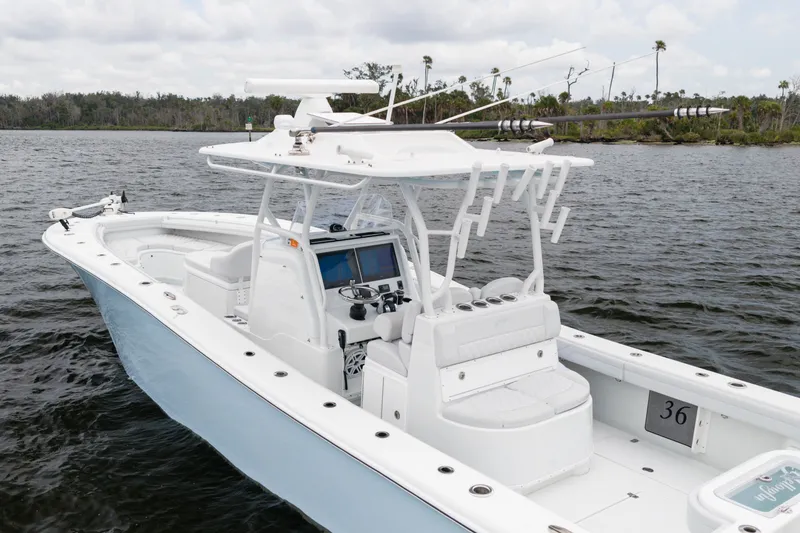 Slide: The Image of 2019 Yellowfin 36 Offshore boat on calm water, featuring sleek design and advanced navigation equipment. - 4