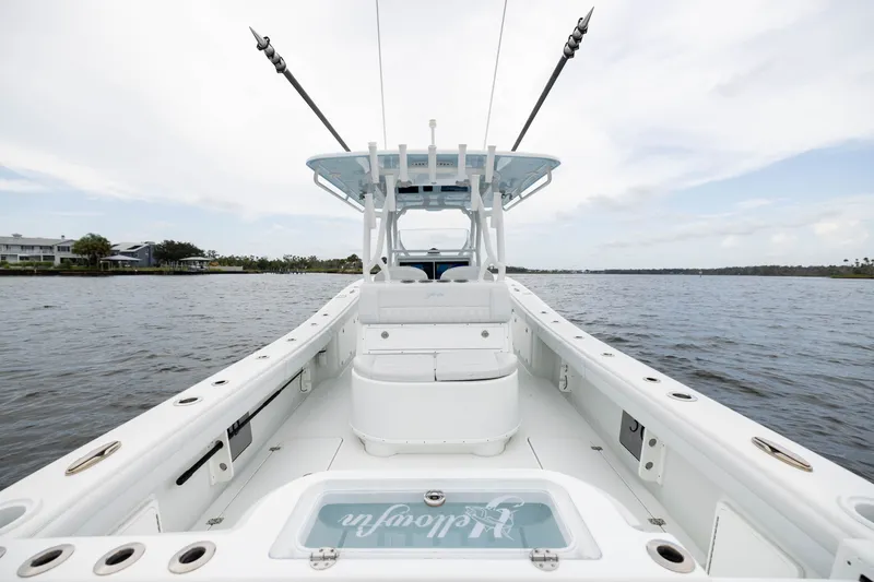 Slide: The Image of 2019 Yellowfin 36 Offshore boat on calm water, showcasing spacious deck and fishing rods. - 36