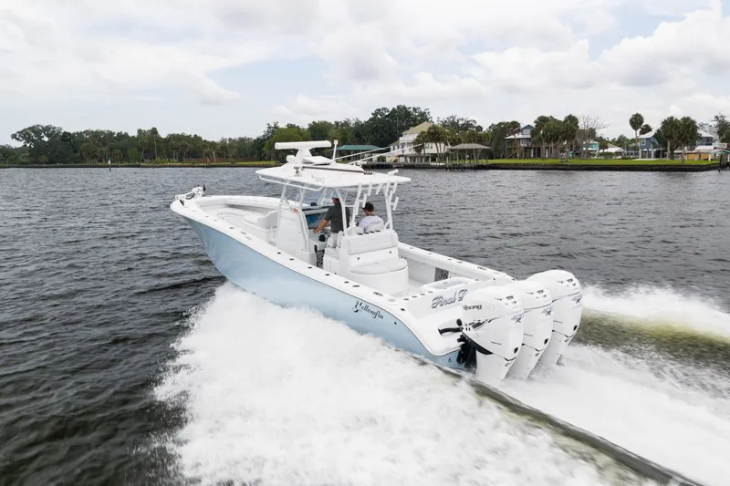 Slide: The Image of 2019 Yellowfin 36 Offshore boat cruising on a scenic waterway. - 9