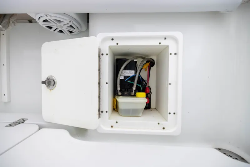 Slide: The Image of 2019 Yellowfin 36 Offshore boat compartment with wiring and fluid container. - 46