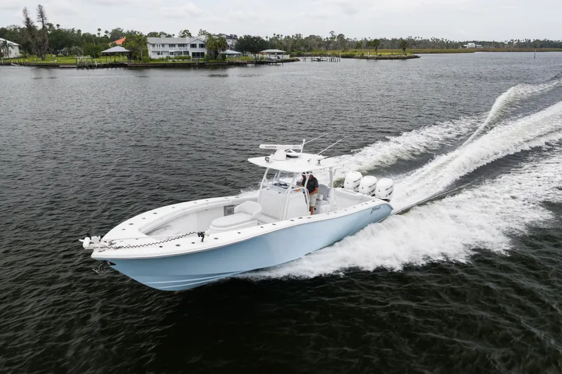 Slide: The Image of 2019 Yellowfin 36 Offshore boat cruising on a scenic waterway. - 8