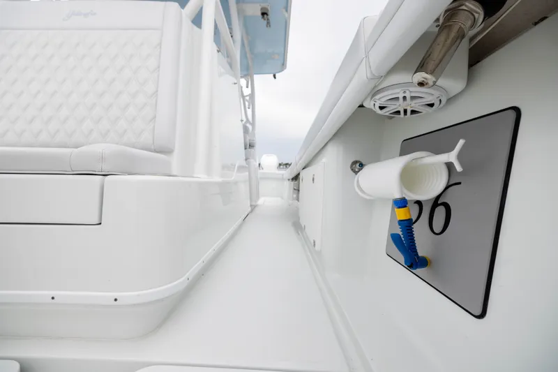 Slide: The Image of 2019 Yellowfin 36 Offshore boat interior with white seating and fishing rod holder. - 25