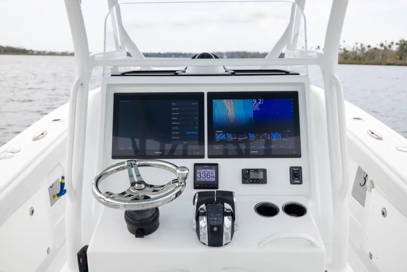 Slide: The Image of 2019 Yellowfin 36 Offshore boat dashboard with dual screens and steering wheel. - 31