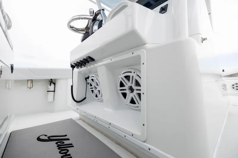 Slide: The Image of 2019 Yellowfin 36 Offshore boat interior with steering wheel and speakers. - 33