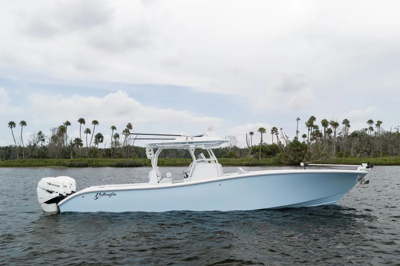 The Image of 2019 Yellowfin 36 Offshore boat on water, with palm trees in the background. - 1