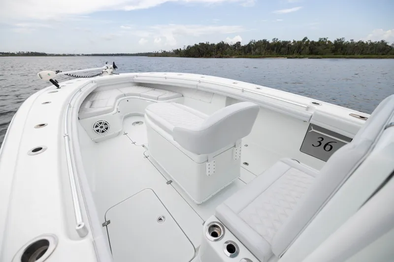 Slide: The Image of 2019 Yellowfin 36 Offshore boat interior with white seating and open water view. - 13