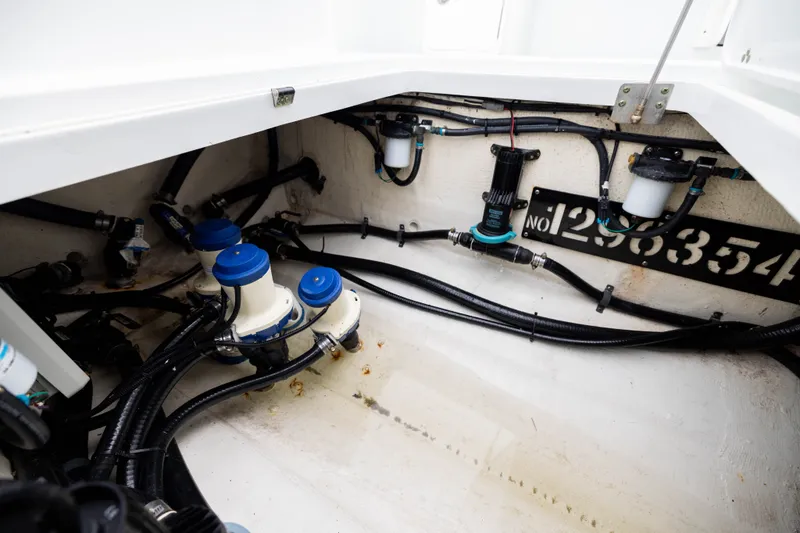 Slide: The Image of 2019 Yellowfin 36 Offshore boat interior showing wiring and plumbing components. - 51