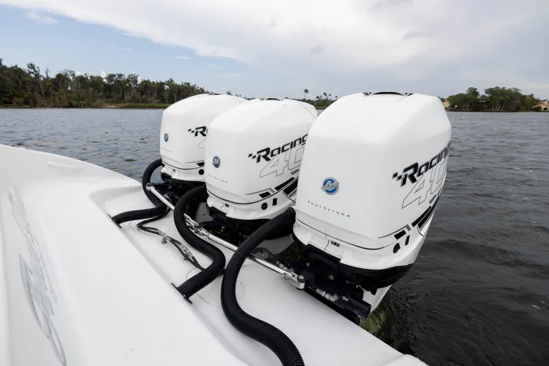 Slide: The Image of 2019 Yellowfin 36 Offshore boat with triple outboard engines on a calm lake. - 48
