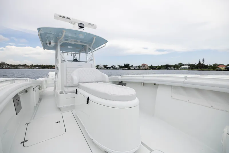 Slide: The Image of 2019 Yellowfin 36 Offshore boat with sleek white interior and Garmin equipment, docked by the water. - 19
