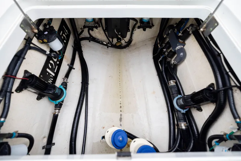Slide: The Image of Engine compartment of a 2019 Yellowfin 36 Offshore boat, showcasing wiring and components. - 49
