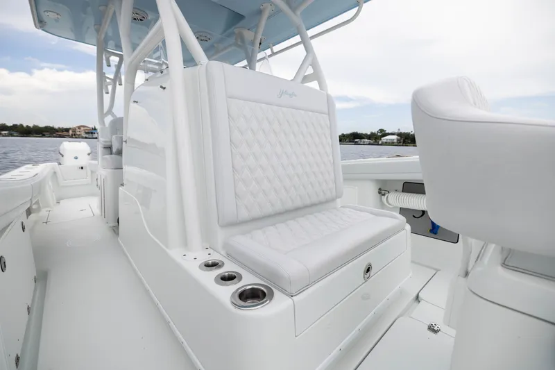 Slide: The Image of 2019 Yellowfin 36 Offshore boat interior with white seating and cup holders. - 22