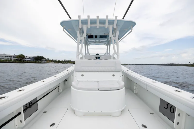 Slide: The Image of 2019 Yellowfin 36 Offshore boat on calm water, showcasing spacious deck and seating. - 39