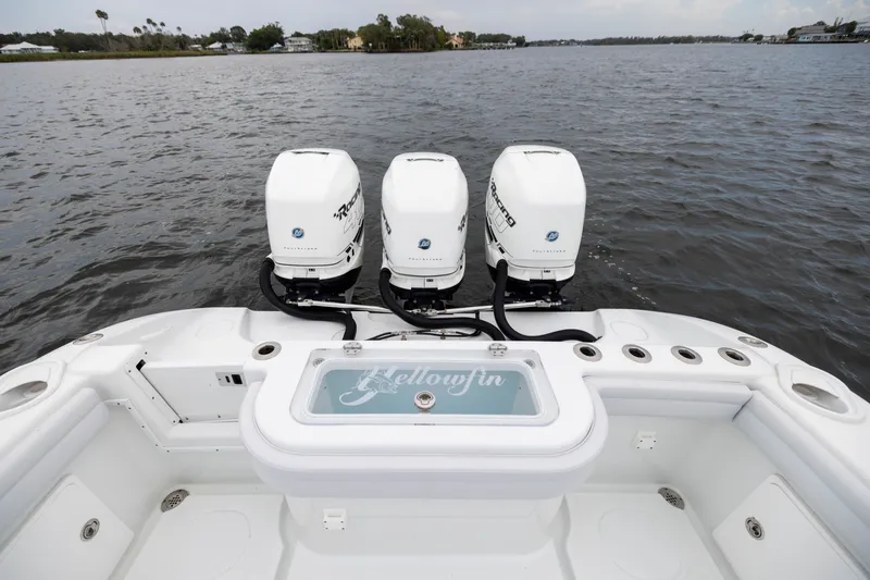 Slide: The Image of 2019 Yellowfin 36 Offshore boat with triple outboard motors on open water. - 45
