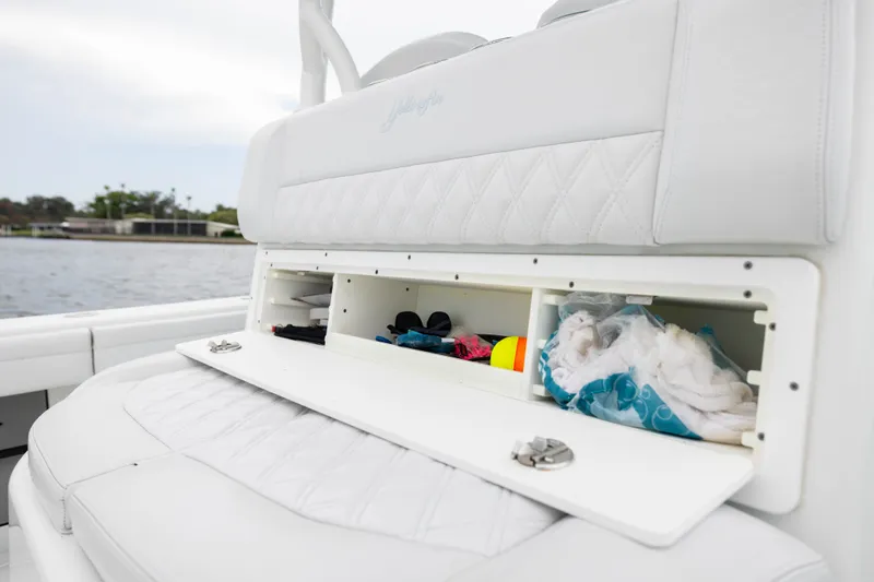 Slide: The Image of 2019 Yellowfin 36 Offshore boat storage compartment with open hatch, showcasing organized interior. - 41
