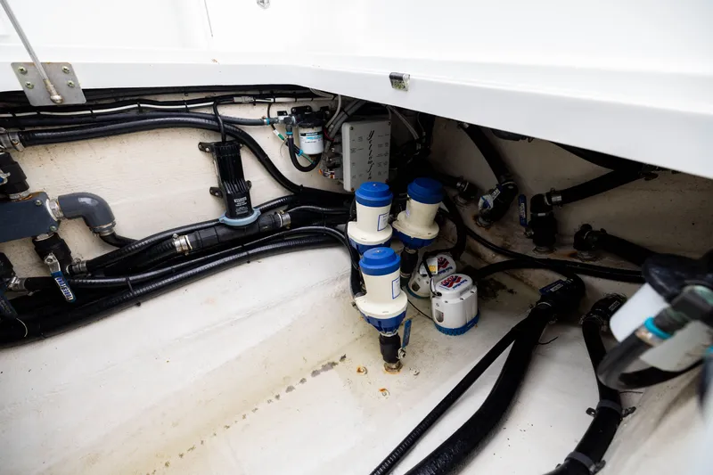 Slide: The Image of 2019 Yellowfin 36 Offshore boat interior showing plumbing and wiring components. - 50