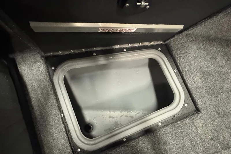 Slide: The Image of Storage compartment in 2026 Tracker Targa V-18 Combo boat, featuring carpeted interior. - 18