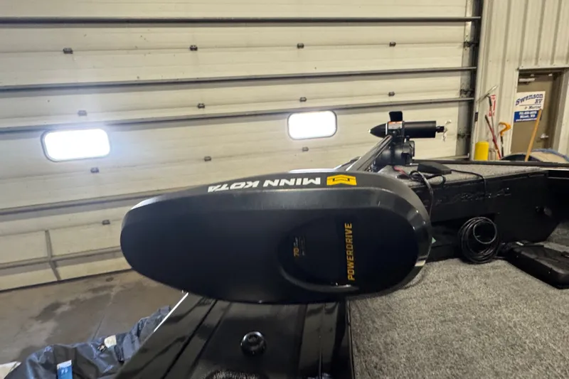 Slide: The Image of 2026 Tracker Targa V-18 Combo boat with Minn Kota PowerDrive motor in a garage. - 17