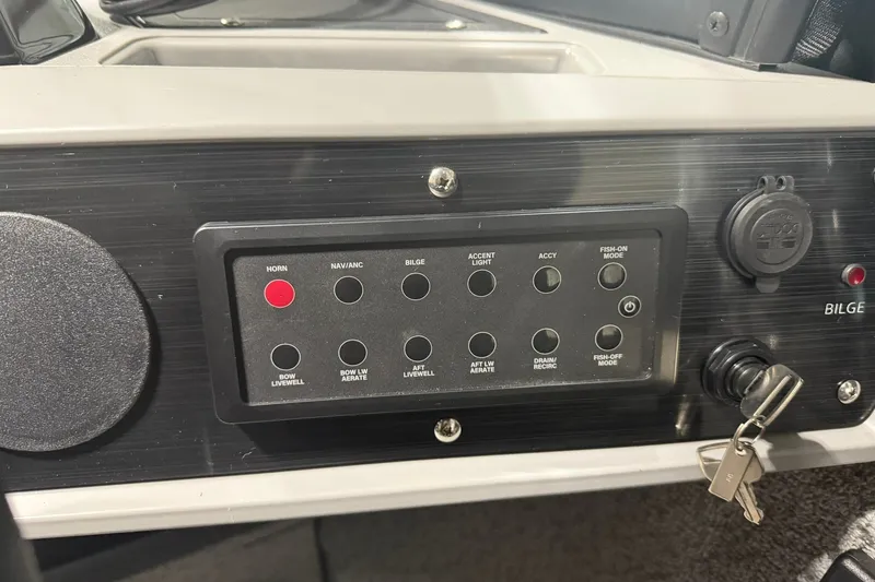 Slide: The Image of Control panel of 2027 Starcraft Fishmaster 196 boat with various function buttons. - 8