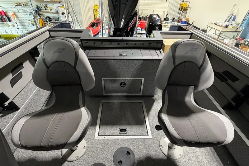 Slide: The Image of Interior of 2027 Starcraft Fishmaster 196 boat with two gray seats and measuring board. - 10