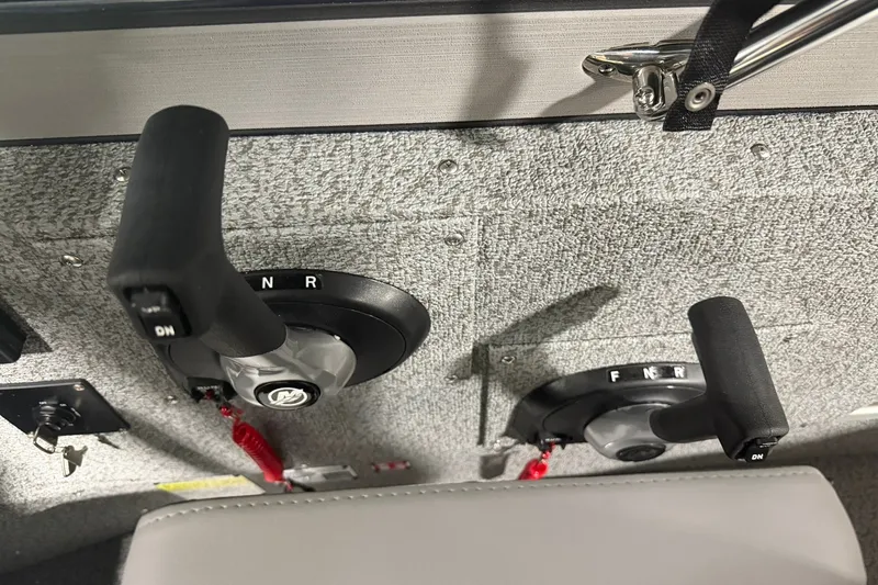 Slide: The Image of Dual throttle controls on a 2027 Starcraft Fishmaster 196 boat dashboard. - 9