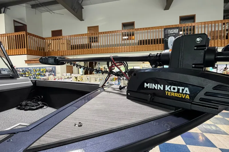 Slide: The Image of 2027 Starcraft Fishmaster 196 boat with Minn Kota Terrova trolling motor in showroom. - 2