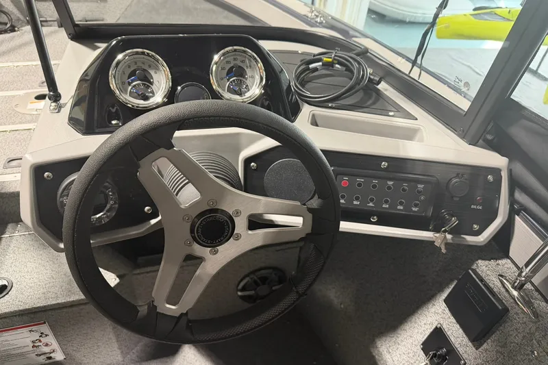 Slide: The Image of Steering console of 2027 Starcraft Fishmaster 196 boat with gauges and controls. - 5