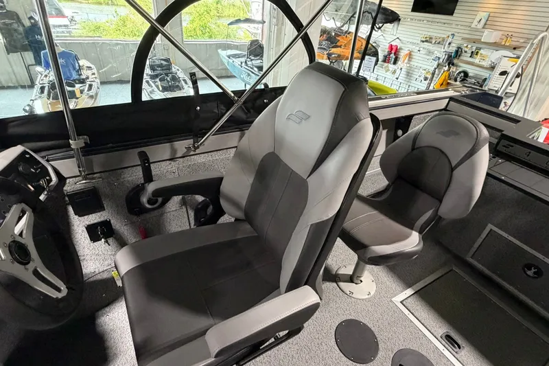 Slide: The Image of Interior of 2027 Starcraft Fishmaster 196 boat, featuring modern seating and steering wheel. - 16