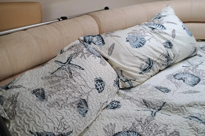 Slide: The Image of Nautical-themed bedding in a 2007 Monterey 250 Cruiser cabin. - 8