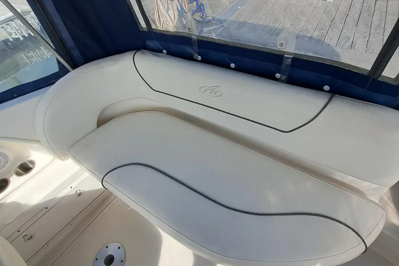 Slide: The Image of 2007 Monterey 250 Cruiser interior seating with white upholstery and blue accents. - 18
