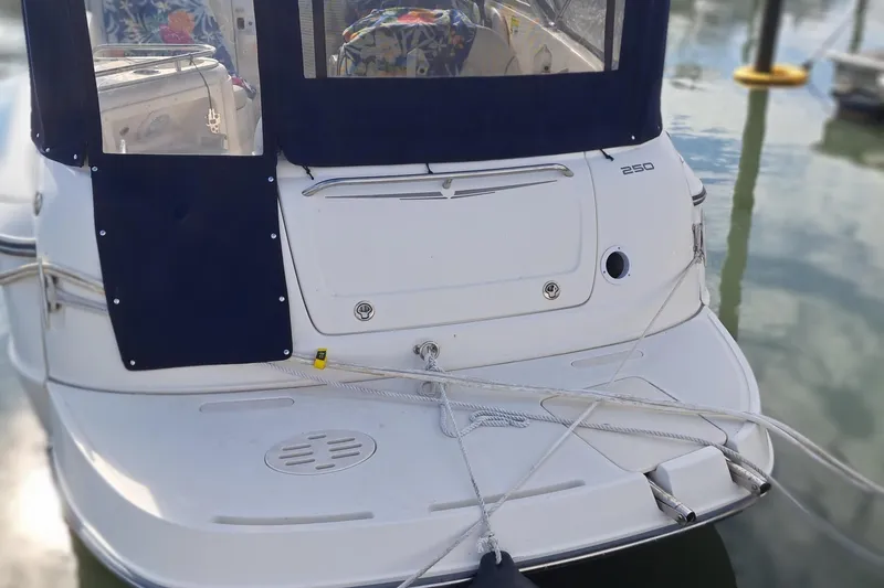 Slide: The Image of 2007 Monterey 250 Cruiser boat docked with navy blue canopy. - 4
