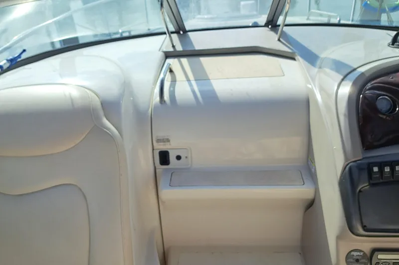 Slide: The Image of Interior view of a 2007 Monterey 250 Cruiser boat cockpit with white seating. - 10