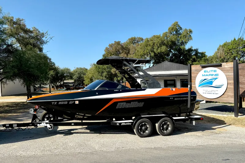 Slide: The Image of 2018 Malibu Wakesetter 21 MLX boat on trailer at Elite Marine dealership. - 1