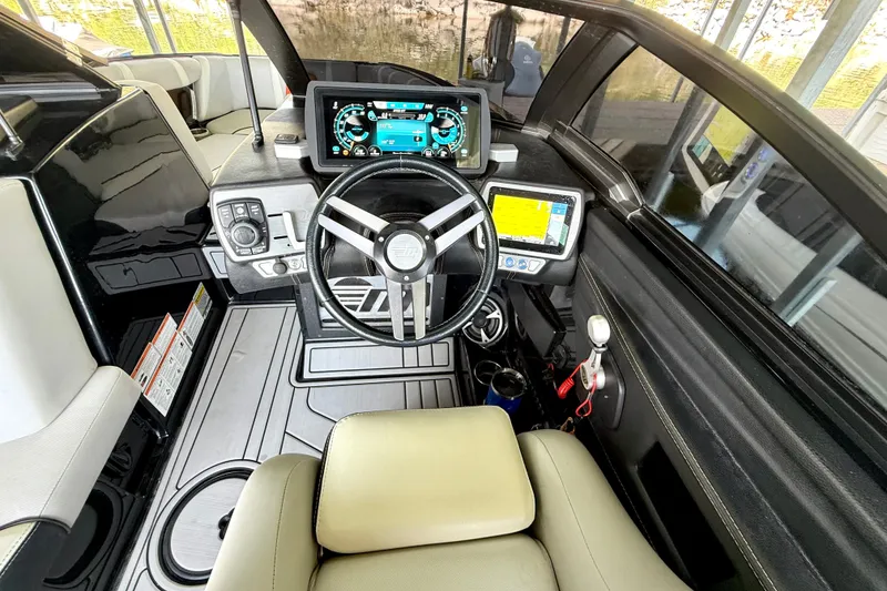 Slide: The Image of 2018 Malibu Wakesetter 21 MLX boat cockpit with modern controls and steering wheel. - 28