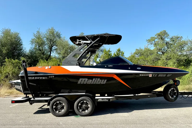 Slide: The Image of 2018 Malibu Wakesetter 21 MLX boat on trailer, parked outdoors. - 15