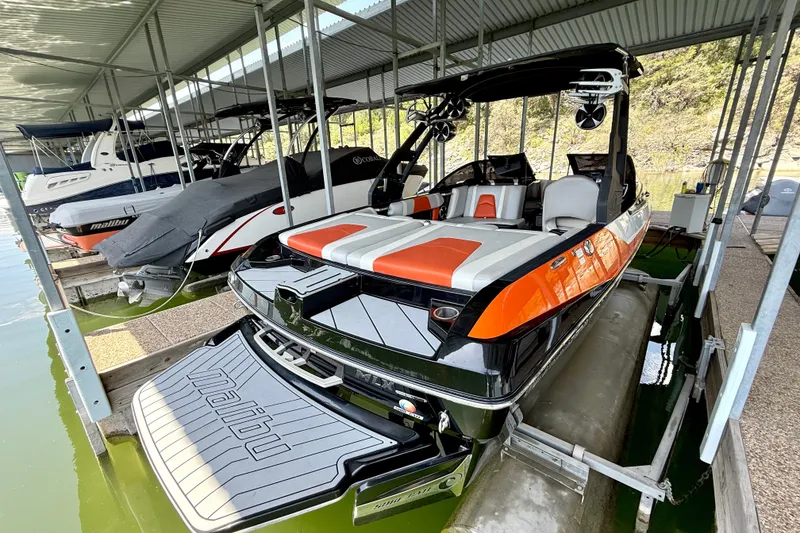 Slide: The Image of 2018 Malibu Wakesetter 21 MLX boat docked in covered marina. - 21