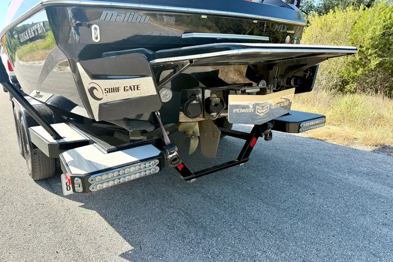 Slide: The Image of 2018 Malibu Wakesetter 21 MLX boat rear view with Surf Gate and Power Wedge features. - 12