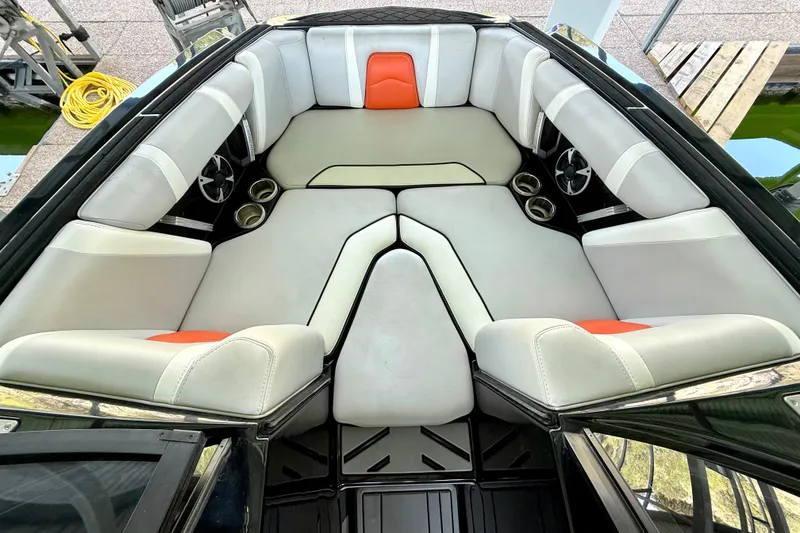 Slide: The Image of 2018 Malibu Wakesetter 21 MLX boat interior with white and orange seating. - 25