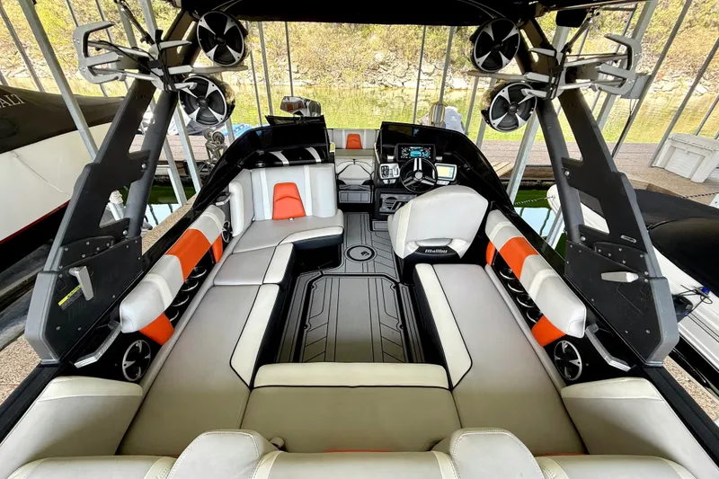 Slide: The Image of 2018 Malibu Wakesetter 21 MLX interior with sleek seating and advanced audio system. - 23