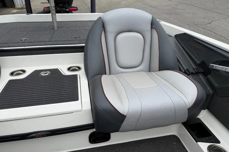 Slide: The Image of 2022 Ranger Z519 boat seat with gray and white upholstery, featuring cup holders and storage. - 16