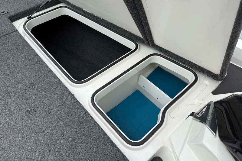 Slide: The Image of 2022 Ranger Z519 boat storage compartments with open lids, showcasing interior design. - 14