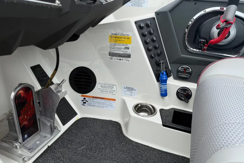 Slide: The Image of 2022 Ranger Z519 boat cockpit with controls, warning labels, and seating area. - 20