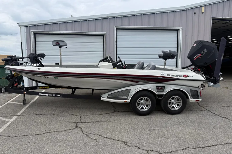 The Image of 2022 Ranger Z519 boat on trailer, parked outside a garage. - 1