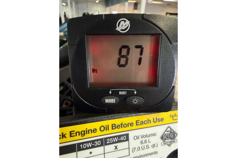 Slide: The Image of Digital hour meter displaying 87 hours on a 2022 Ranger Z519 boat. - 24