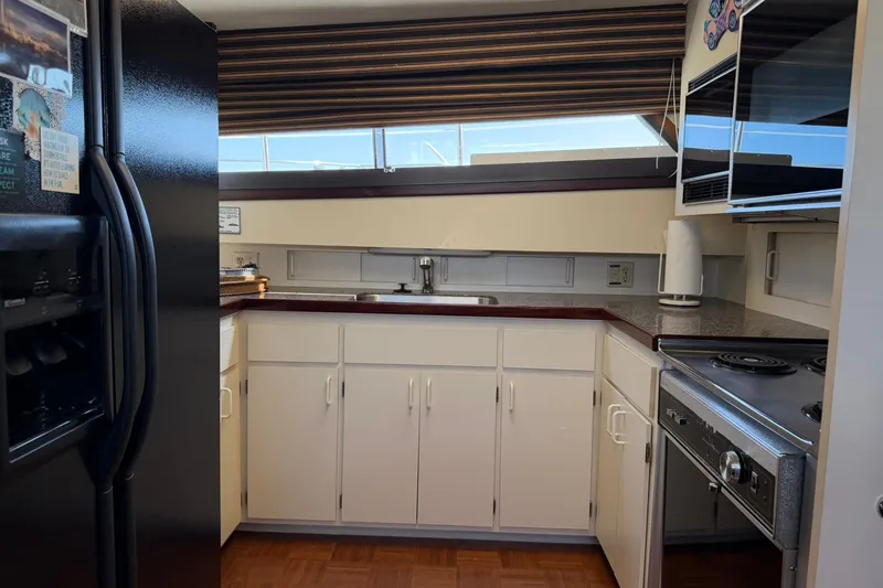 Slide: The Image of Kitchen interior of 1986 Hatteras 63 Cockpit Motor Yacht with modern appliances. - 29
