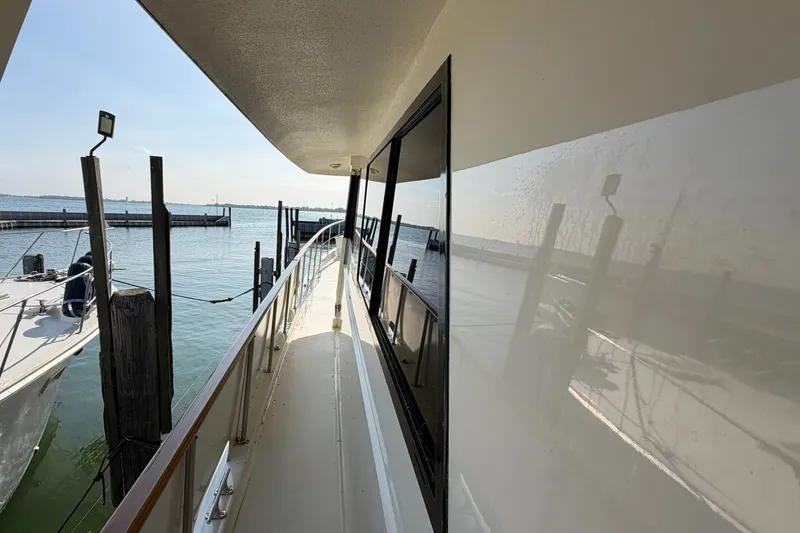 Slide: The Image of Side deck view of 1986 Hatteras 63 Cockpit Motor Yacht at marina. - 70
